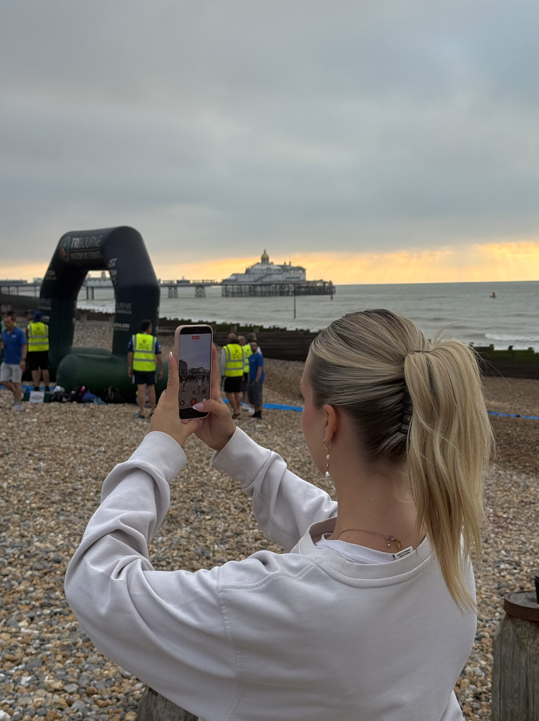 Filming content on a pebble beach at sunset